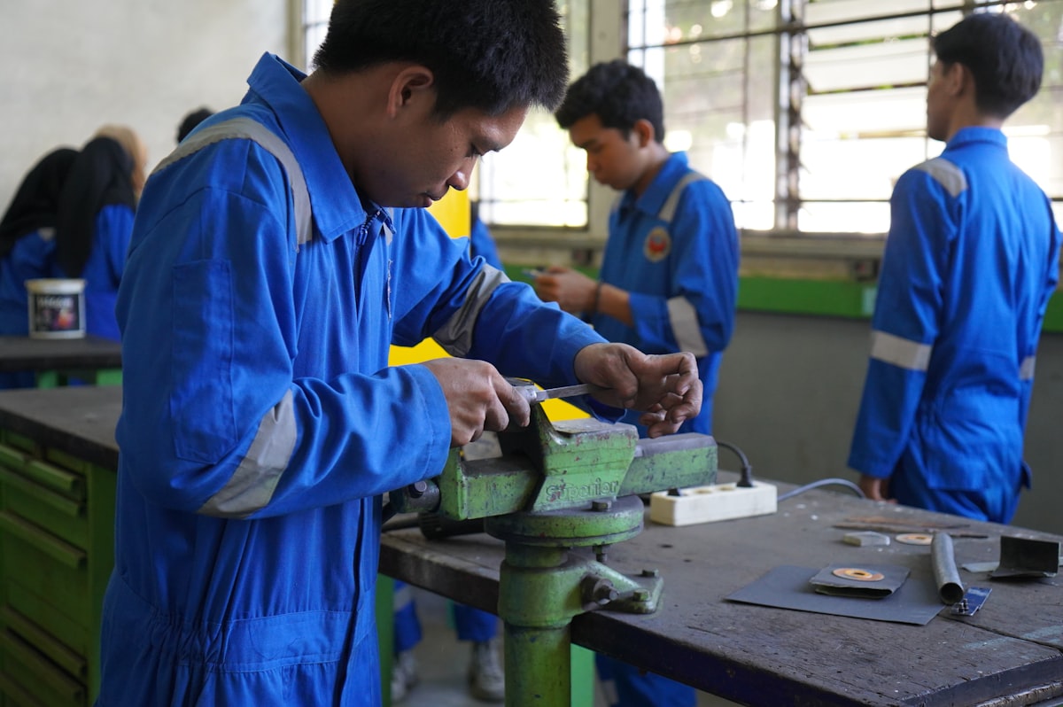 A student working at a manufacturing station, representing a newly added CTE pathway at a comprehensive high school